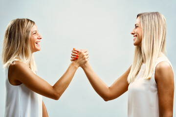 Happy women, distinctive handshake