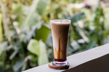 iced coffee on grey background with beans coffee