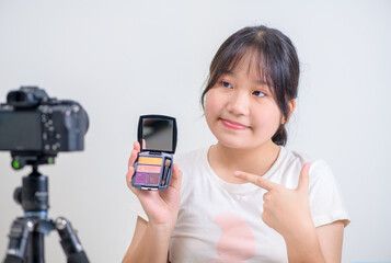 Beauty girl blogger concept, Asian woman use brush to applying eye shadow