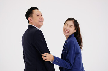 Young businesswoman and young businessman smiling on a white background.