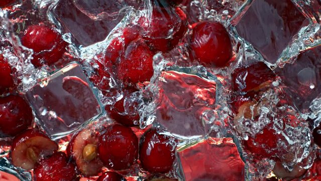 Super Slow Motion Shot of Water Wave Splashing on Cherries and Ice Cubes at 1000fps.