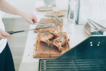 Chef's Culinary Art: Grilled Chicken Being Cut at Barbecue