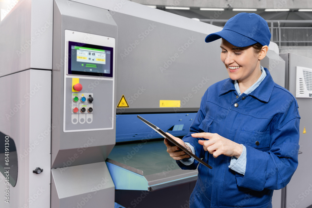 Aufkleber woman worker with digital tablet controls automatic machine tool in smart factory.