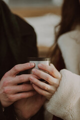 couple holding cup of tea