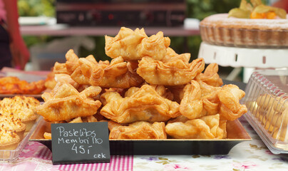 Pastellitos membrillo, deep-fried crispy Argentinian pastries coated with a sugar glaze displayed...