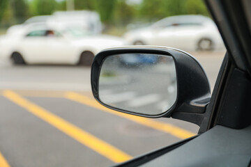 A car mirror reflects life's perspectives and symbolizes self-reflection, awareness, and the...
