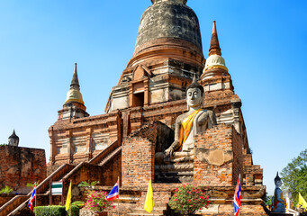 Big Buddha statue in front of temple Wat Yai Chai Mongkol (or Mongkhon) in Ayutthaya Historical Park, Thailand.