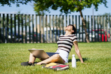 Fototapeta premium Female freelancer with laptop in park