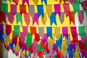 Flags of different colors hanging from a rope. Decoration of Sao Joao. June celebration.