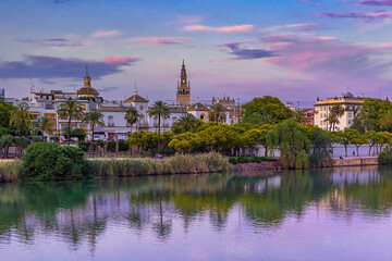 Boulevard and embankment of Guadalquivir river, Maestranza and Giralda at sunset at sunset,...