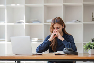 Asian women are bored from their online studies, have a sad face and have been tired from their...