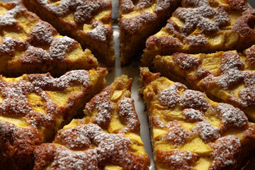 Cooked pie with bananas and apples. Sliced banana pie on a plate. Delicious sweet pie on a plate ready to eat