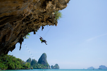 silhouette of climber hiking high on top of the rock mountain with rope,active sport adventure extreme exercise,concept for strong athlete