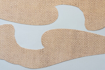 two shapes made of scrapbook paper with weave pattern on blank paper