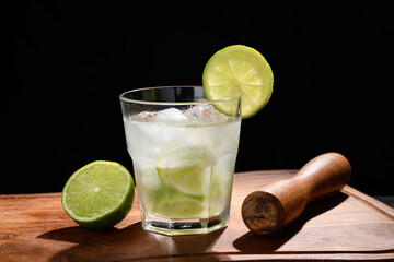 lemon and cachaça caipirinha, a typical Brazilian drink a glass with caipirinha on a black background