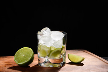  a glass with lemon and ice for a drink on a black background