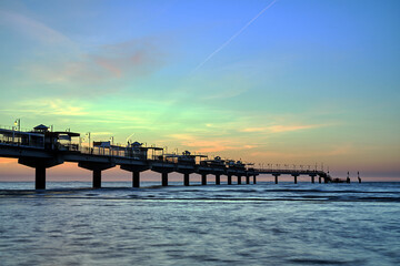Fototapeta premium Concrete pier in the evening by the Baltic Sea in Miedzyzdroje, Poland
