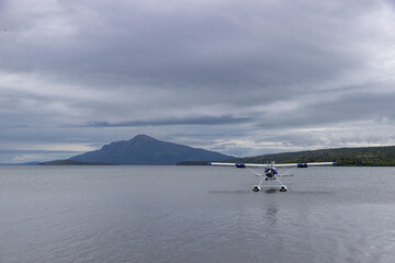 Fototapeta premium Small bush plane on a pretty lake in Alaska. Adventure travel through wilderness.