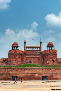 Red Fort or Lal Qila in Delhi with indian flag on foreground with moody sk.UNESCO World heritage site. Discover the India. Open world after covid-19