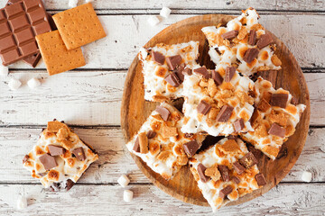 Smores brownies dessert platter. Top down view table scene on a white wood background. - obrazy, fototapety, plakaty