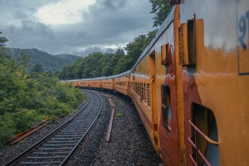 View from Indian train to unique and amazed nature scenic landscape of rain forest near Dudhsagar Falls. Goa, India. Tourism beautiful destination place.  Discover India. Open world after covid-19