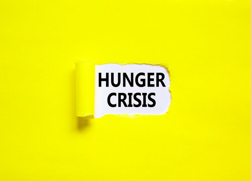Hunger crisis symbol. Concept words Hunger crisis on beautiful white paper on a beautiful yellow background. Business, support and Hunger crisis concept. Copy space.