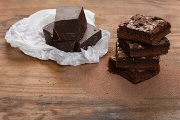chocolate brownie, stacked on a wooden base