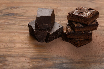 chocolate brownie, stacked on a wooden base