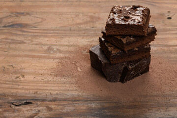 chocolate brownie, stacked on a wooden base