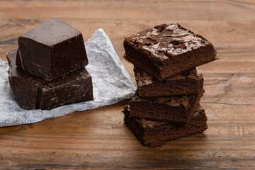 chocolate brownie, stacked on a wooden base