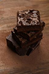chocolate brownie, stacked on a wooden base