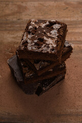 chocolate brownie, stacked on a wooden base