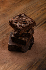 chocolate brownie, stacked on a wooden base