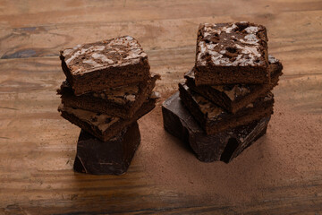 chocolate brownie, stacked on a wooden base