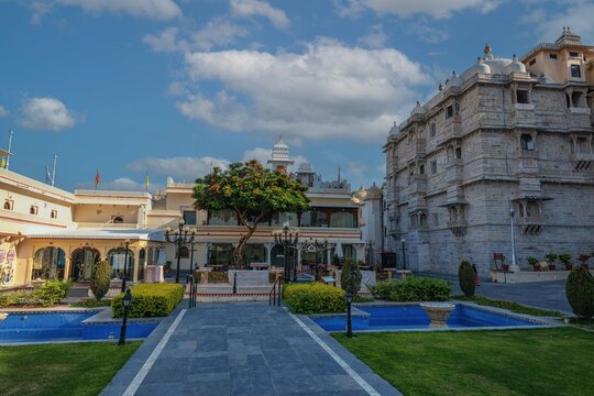 Romantic and luxury City Palace of Maharajah in Udaipur on Lake Pichola at sunset. Rajasthan, Discover the beauty of India. Open world after covid-19