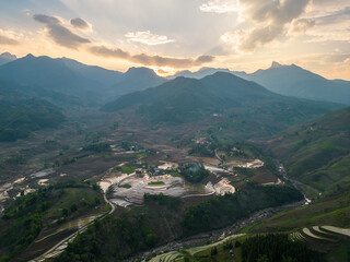 The pouring water season makes the terraced fields of Y Ty commune, Lao Cai province, Vietnam appear with brown soil blending with the beautiful sky.