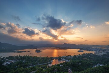 Aerial panoramic view of Udaipur, Lake palace, Lake Pichola at beautiful sunset and moody sky. Rajasthan, Discover the beauty of India. Open world after covid-19 - 614229950