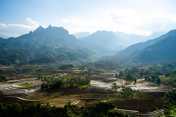 The pouring water season makes the terraced fields of Y Ty commune, Lao Cai province, Vietnam appear with brown soil blending with the beautiful sky.