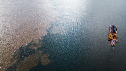 Water Confluence Between Tapajós and Amazon River in Brazil, Aerial Drone Fly Above Clearwater Source Stream - obrazy, fototapety, plakaty