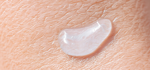 Fototapeta premium Collagen And Hyaluron Serum Gel On Skin. Splashing of Hyaluron gel. Liquid hyaluronic acid gel on skin. Cosmetic water gel texture on human skin background. Textured background. skin care product.