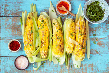 Grilled sweet corn with smoked sea salt, cilantro and sauce.Summer vegan dinner, snack.