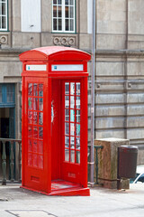 Fototapeta premium Traditional red Portuguese phone booth in Porto