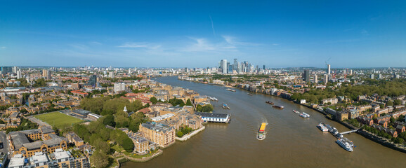 Fototapeta premium Beautiful panoramic view of London Thames river with Canary Wharf skyline in the background. Beautiful London district.