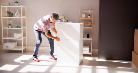 Man Carrying Furniture At Home