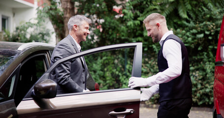 Man Giving Car Key To Male Valet
