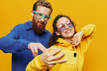 Woman and man funny couple with phones hand social networking and communication crooked do selfies...