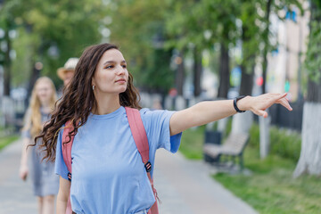 young girl shows the direction to the right with her hand