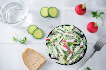 Radish cucumber parsley dill salad in a bowl