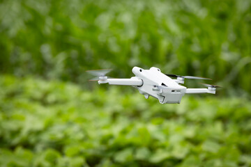 Agricultural drone with multispectral camera analyzing soil humidity and crops health in soybean field.