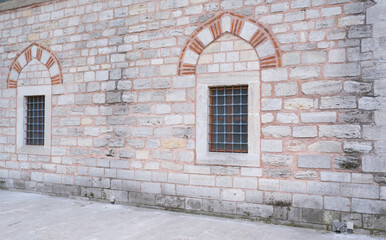 Window on a brick wall under brick arch.